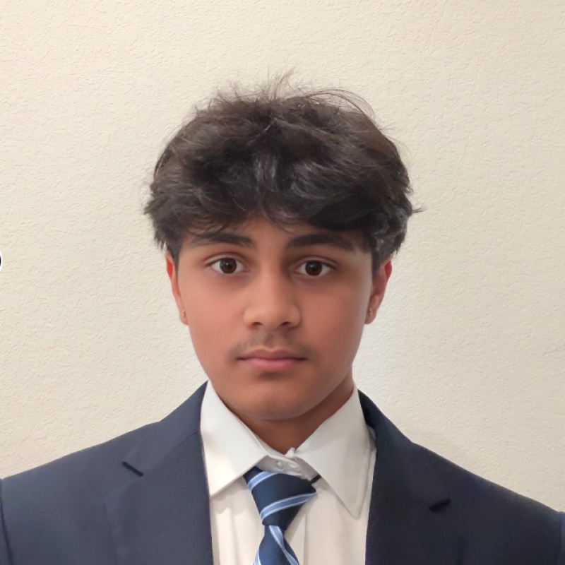 Ryan Shankar wearing a navy suit and striped tie